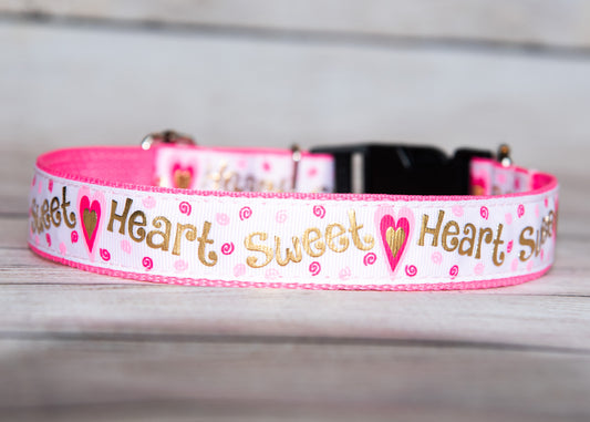 Sweet Heart dog collar. Pink and white with hearts and irredescent gold writing. 1 inch wide, 4 adjustable sizes.