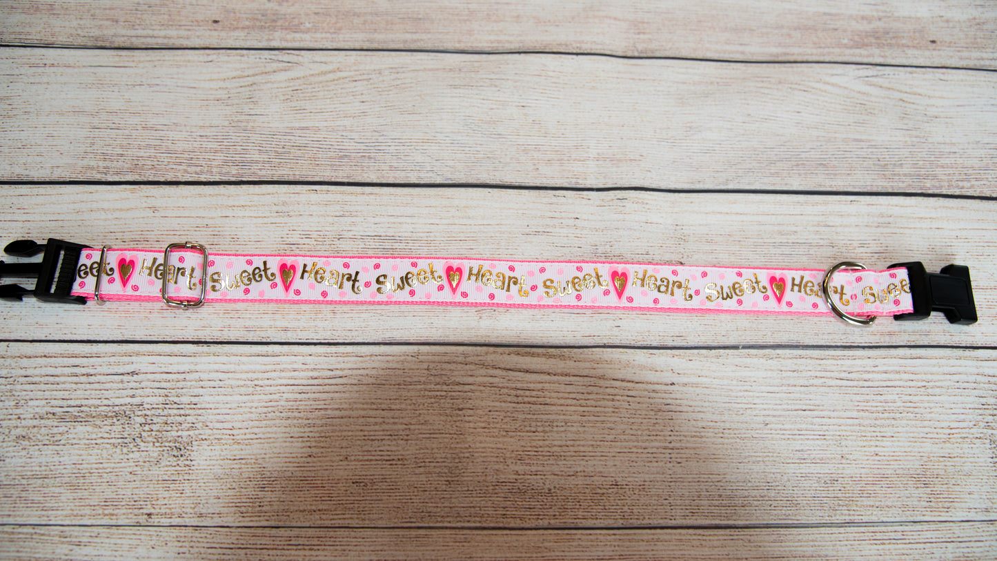 Sweet Heart dog collar. Pink and white with hearts and irredescent gold writing. 1 inch wide, 4 adjustable sizes.