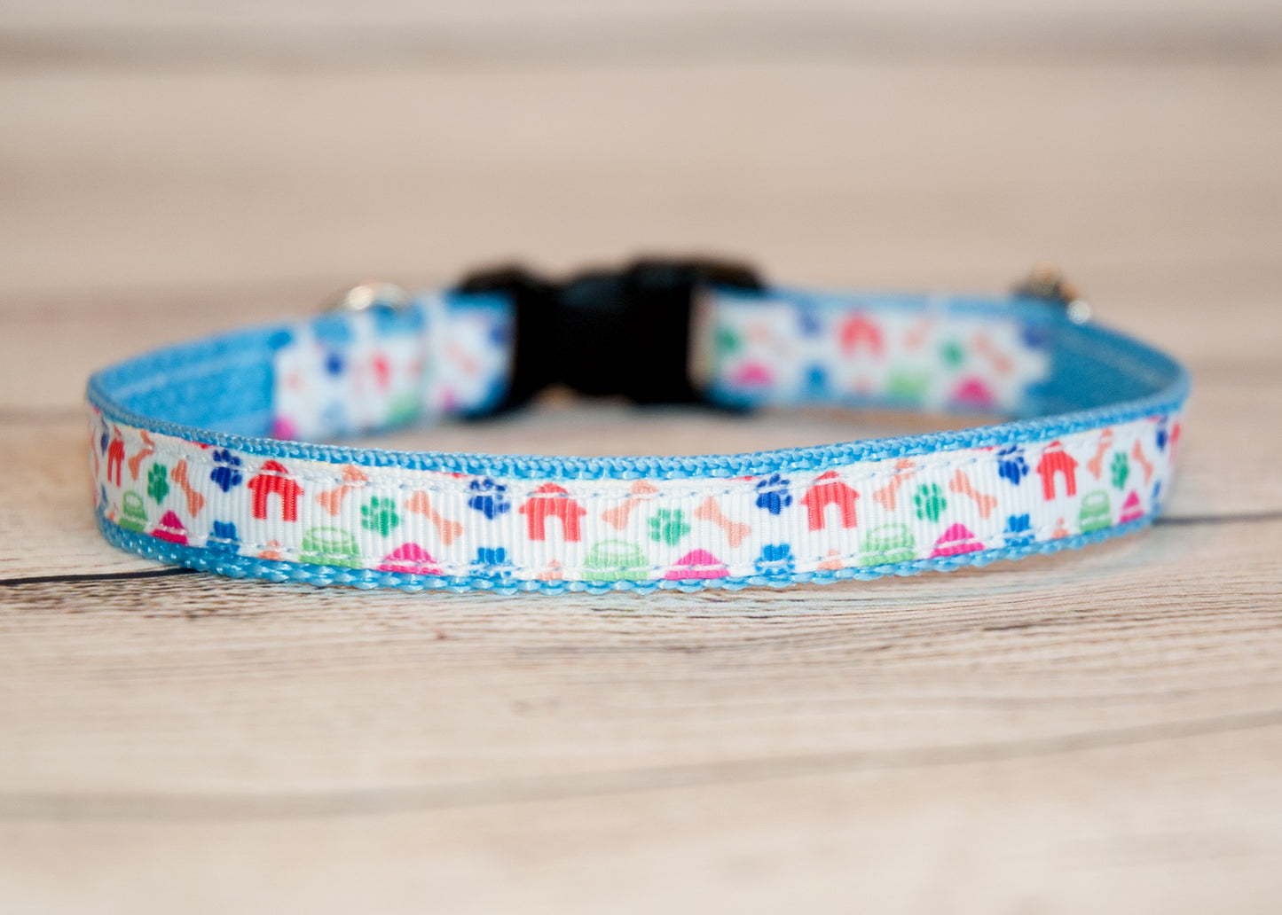 Dog houses, pawprints, and bones dog collar. 1/2" wide for small dogs or cats.